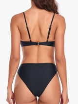 back view of a woman wearing a black bikini with adjustable straps and a clasp closure