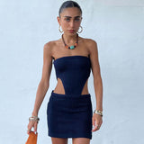 Woman wearing a navy blue strapless ribbed knit mini dress with cutouts
