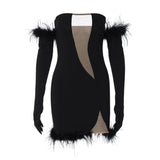 Product shot of a black strapless mini dress with feather trim, cut-out detail, and detachable long sleeves.