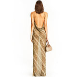 back view of a woman wearing a long snake print slip dress with a cowl neck and spaghetti straps