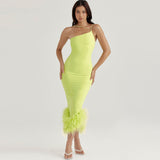 full body shot of a woman in a lime green one-shoulder dress
