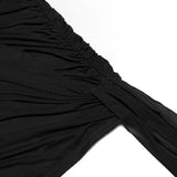 Close-up of the ruched detailing on the black mini dress.