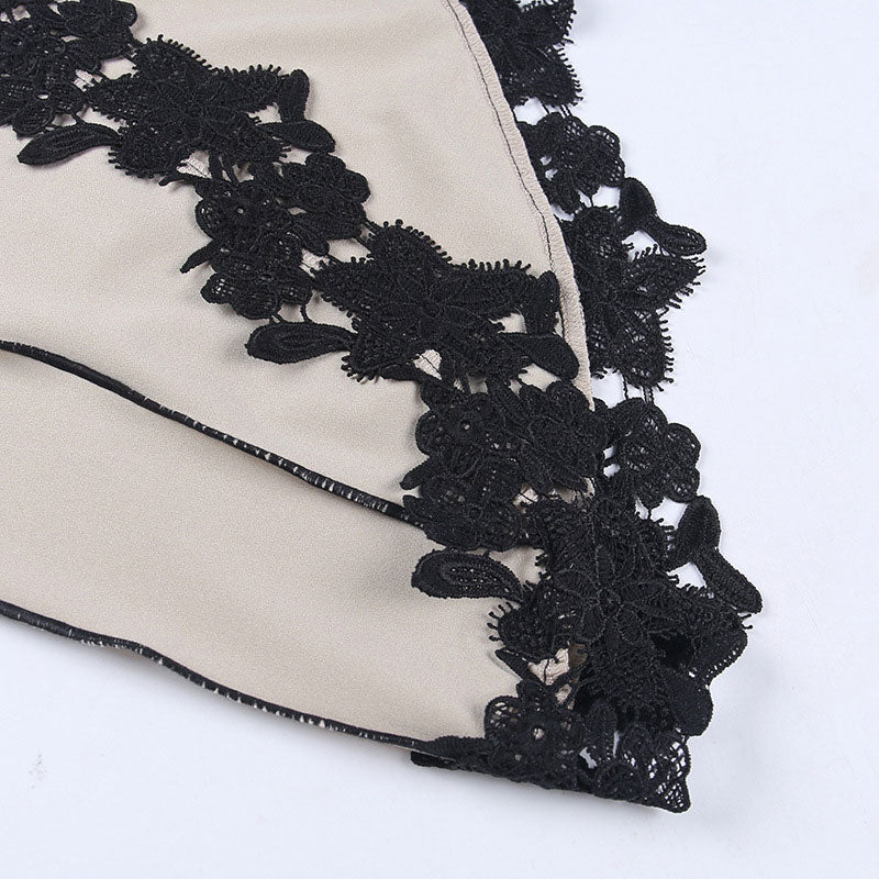 close-up of black lace trim on beige dress