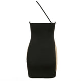back view of a black and nude asymmetrical mini dress with a sheer side panel