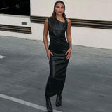 woman wearing a black faux leather column dress with an asymmetrical neckline and ruching detail