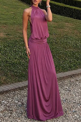 woman wearing a plum halter neck maxi dress outdoors