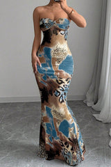 Woman wearing a long, strapless, bodycon maxi dress with an abstract animal print.