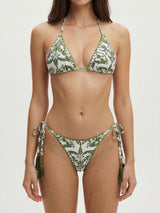 Front view of a white bikini with a green ornate pattern and green tassels.