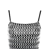 Close-up of the square neckline of a black and white chevron print maxi dress.