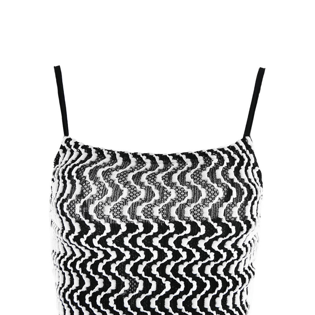 Close-up of the square neckline of a black and white chevron print maxi dress.