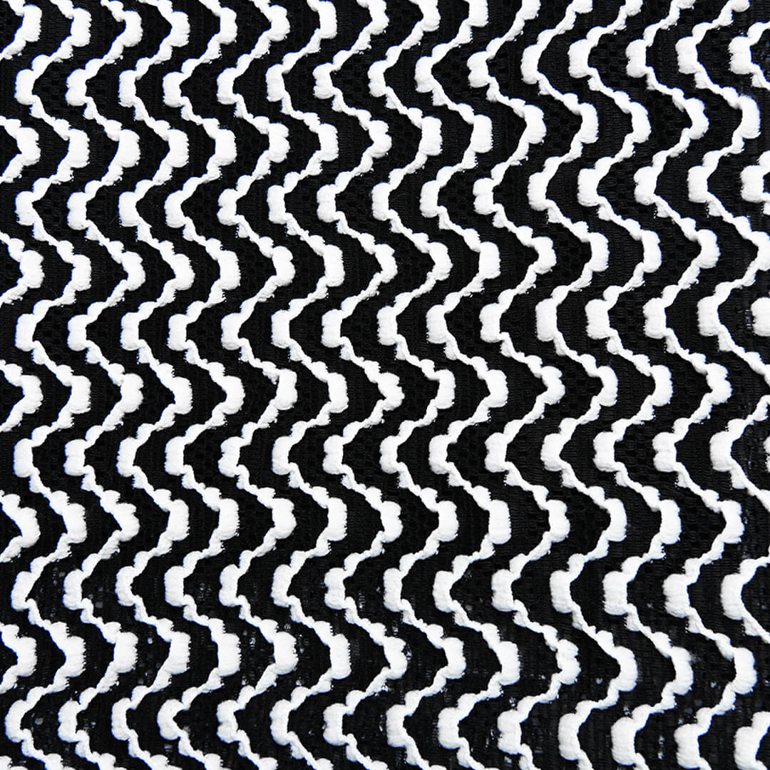 Close-up of the black and white chevron knit fabric pattern.