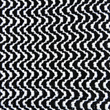 Close-up of the black and white chevron knit fabric pattern.