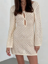 woman wearing a cream-colored crochet knit mini dress with long bell sleeves and a keyhole neckline