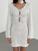 woman wearing a white crochet knit mini dress with long bell sleeves and a keyhole neckline