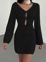 woman wearing a black crochet knit mini dress with long bell sleeves and a keyhole neckline