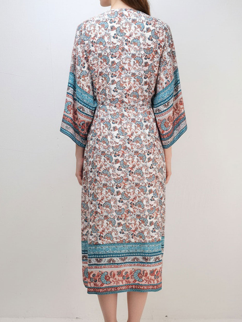 Back view of a woman wearing a long, floral print kimono.