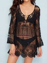 Woman wearing a black crochet knit tunic over a bikini