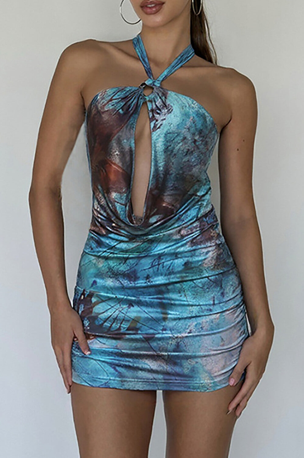 Close-up of a red abstract print halter mini dress with ruched detailing.