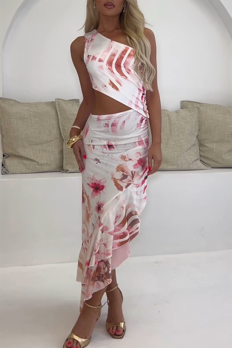 Woman in a white one-shoulder floral print maxi dress with a ruffled hem.