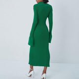 Back view of a woman in a green ribbed knit midi dress with bell sleeves.