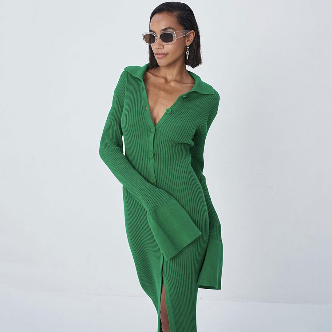 Close-up of a woman wearing a green ribbed knit midi dress with a collared neckline and button-down front, accessorized with sunglasses and earrings.