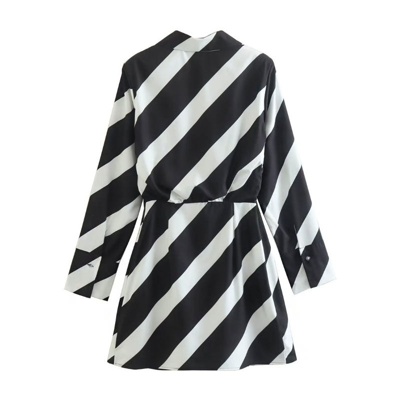 Back view of a black and white striped long-sleeved mini dress with a pointed collar and wrap-style front, laid flat.