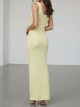 back view of a woman in a pale yellow knit maxi dress
