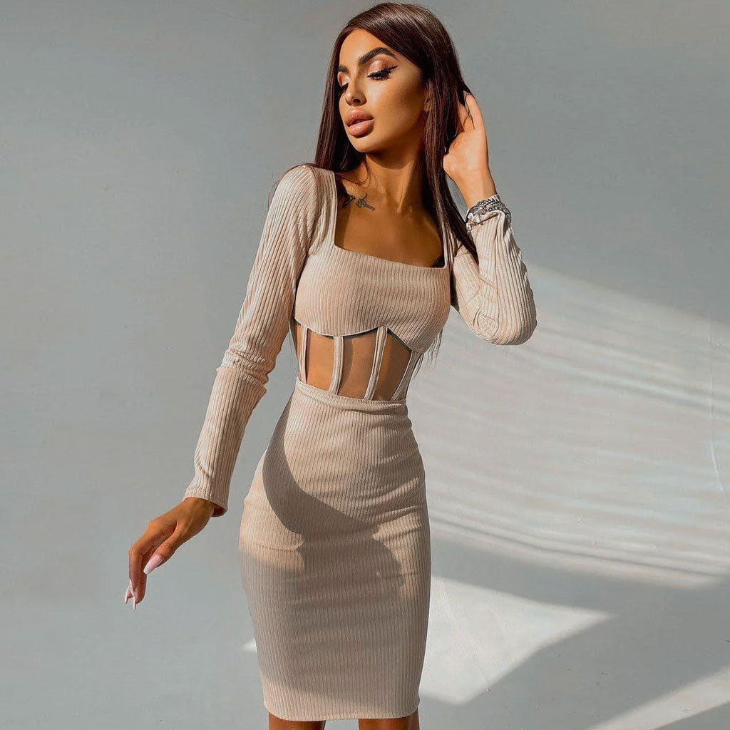 Close-up of a woman in a beige long-sleeved knit dress featuring a square neckline and a sheer midriff panel.