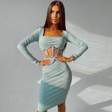 Woman wearing a light blue ribbed knit midi dress with long sleeves and a square neckline, featuring sheer paneling at the waist.