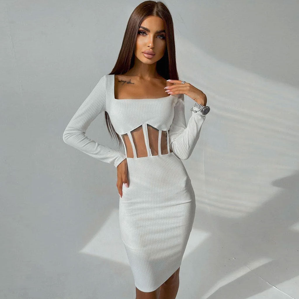 Woman wearing a white long-sleeved bodycon dress with sheer midriff paneling and a square neckline.