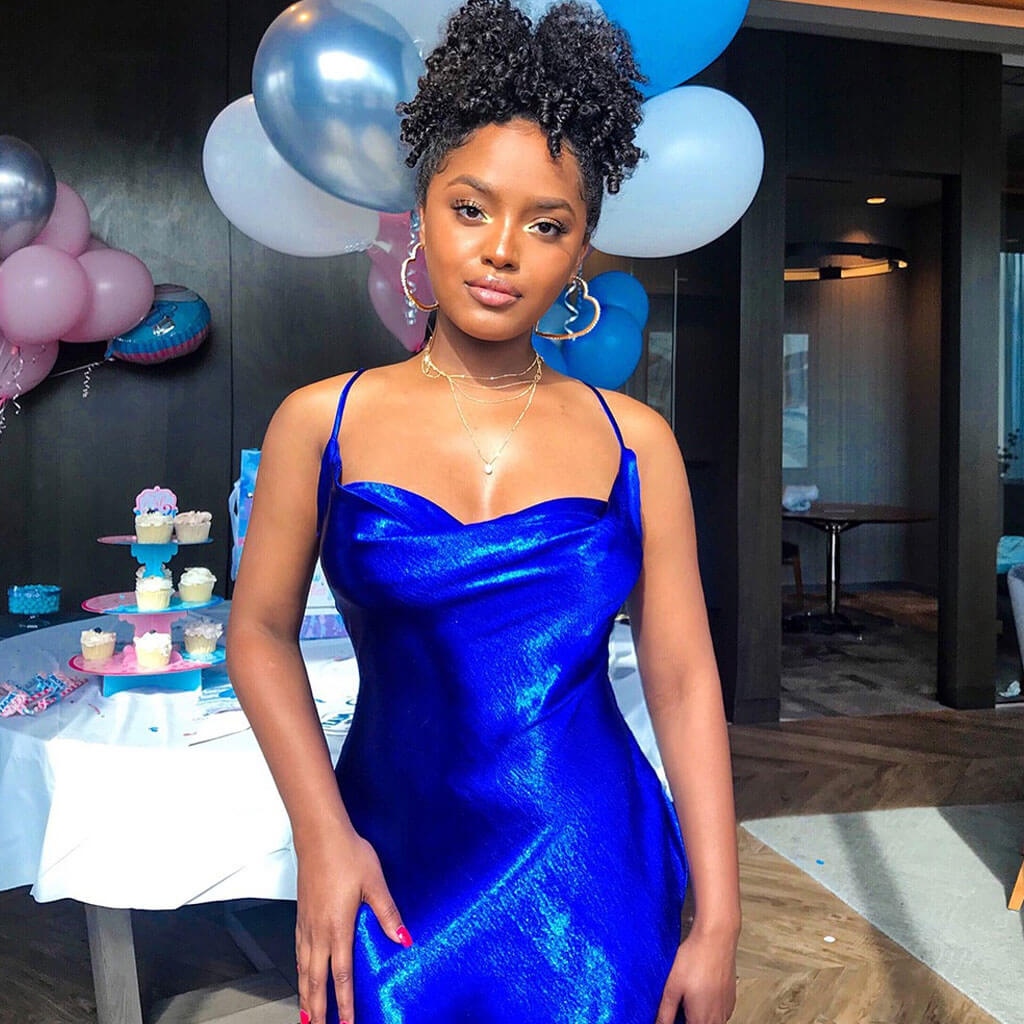Woman in a royal blue satin slip dress at a party