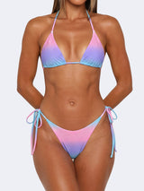 woman wearing a pink, purple, and blue ombre bikini with sparkle embellishments