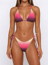woman wearing a pink, purple, and yellow ombre bikini with sparkle embellishments