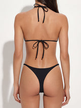 front view of a black string bikini bottom with decorative hardware on the sides