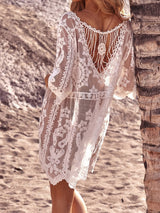 Back view of a white lace beach cover-up showing an open back design