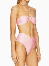 Side view of a pink strapless bikini with a halter strap and pearl detail.