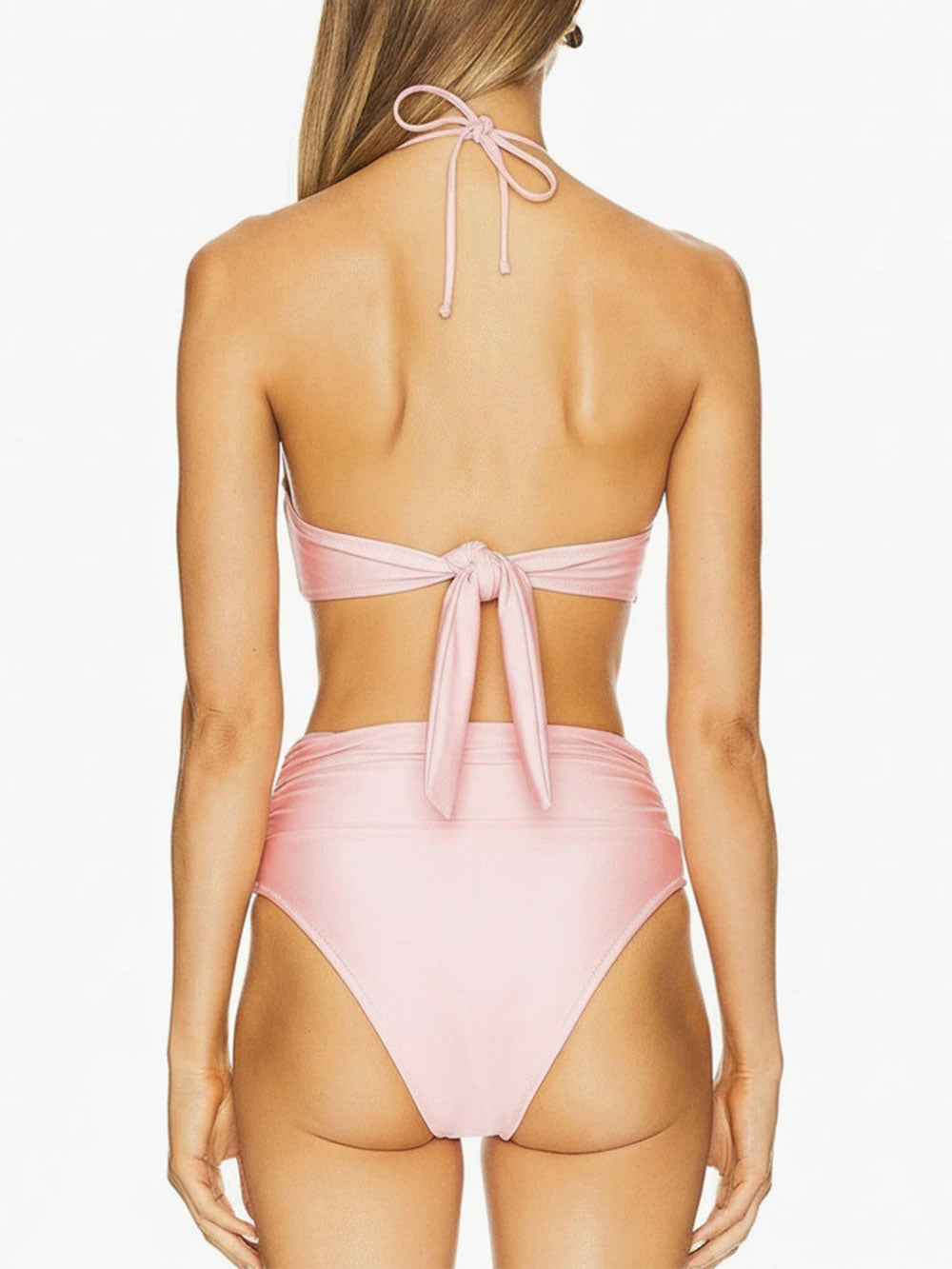 Back view of a pink strapless bikini with a halter strap and pearl detail.
