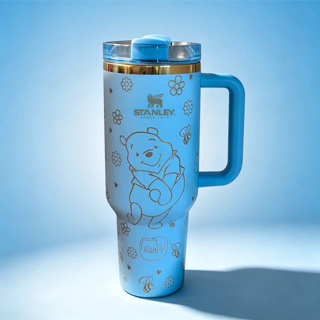 Stanley 40oz insulated tumbler featuring cute blue bear illustrations, paw prints and floral accents