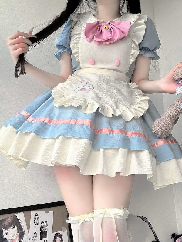 Close-up of a person wearing a blue and white maid-style dress with pink accents and a teddy bear.