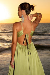 Rear view of a woman's back and neck in a lime green halter maxi dress, showcasing the open back detail and accessories.