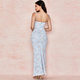 back view of a woman in a light blue floral print maxi dress