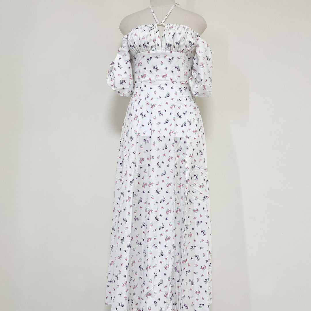 Mannequin displaying a white floral print maxi dress with off-the-shoulder sleeves and halter neckline