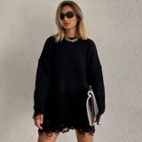 woman in black distressed knit sweater dress with sunglasses and necklace
