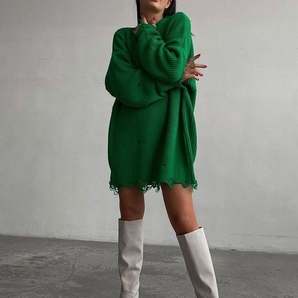 Close-up of a green distressed oversized knit tunic sweater