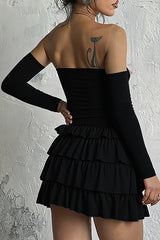 Back view of the black off-the-shoulder dress with a layered ruffled skirt.