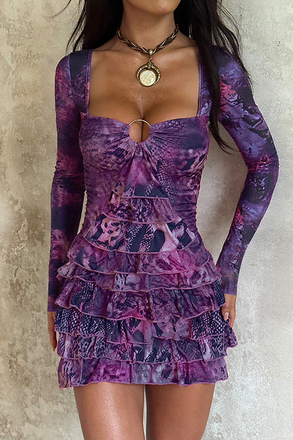woman wearing a purple long-sleeved mini dress with a square neckline and ruffled hem