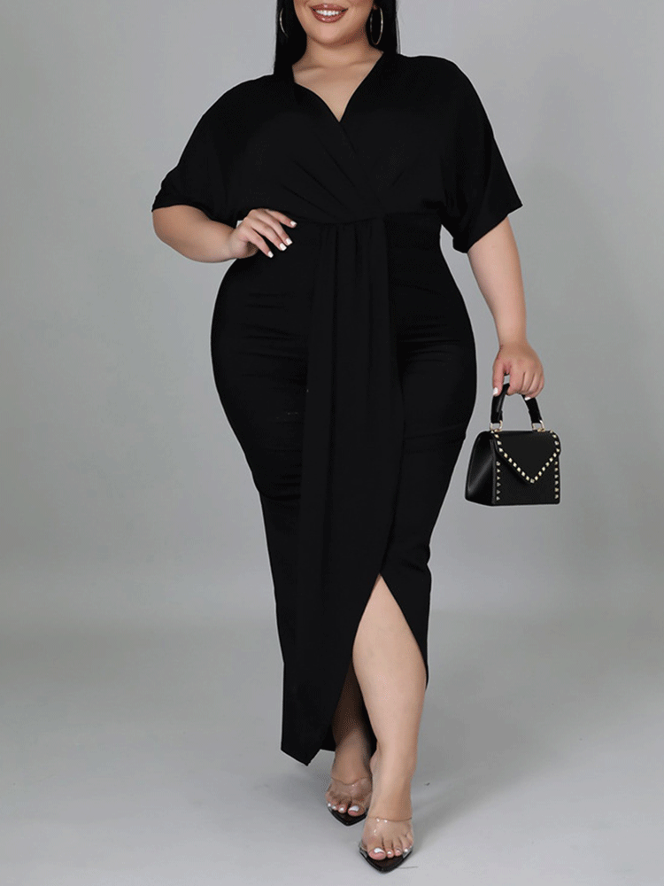 Woman in a black maxi dress with a wrap neckline and high slit