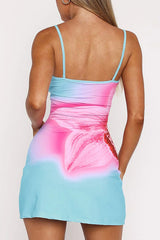 Woman wearing a blue and pink floral print bodycon mini dress from the back