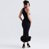 Back view of a woman in a black halter neck midi dress with a ruffled hem