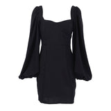 Front view of a black mini dress with puff sleeves
